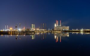 Esbjerg Harbor at night, fully illuminated, viewed from the water – featured on ProAssign's Contact page.