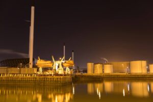 Illuminated Esbjerg Harbor at night, seen from the water – showcasing ProAssign’s maritime connections.